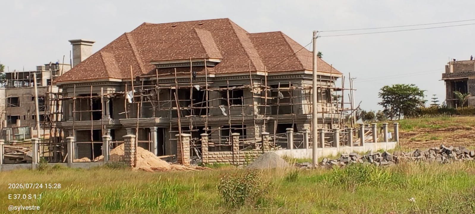 Large residential building under construction with scaffolding